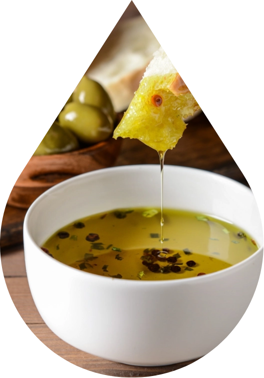 Bread dipped into a bowl of extra virgin olive oil seasoned with herbs and spices.